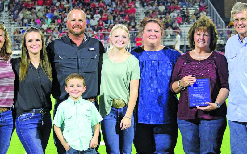 Sentinel Photo/Jessica Shepard Tidehaven Athletic Booster Club inducted Diana Fisher into the Hall of Fame during halftime Friday, Sept. 9. Family members were on hand to receive the plaque in Fisher's stead. Fisher's sporting accomplishments included volleyball, basketball, and track and field. Fisher was also the first female athlete from Tidehaven to qualify at the state track meet throughout her high school career. She also achieved All District in basketball in her sophomore, junior, and senior years.