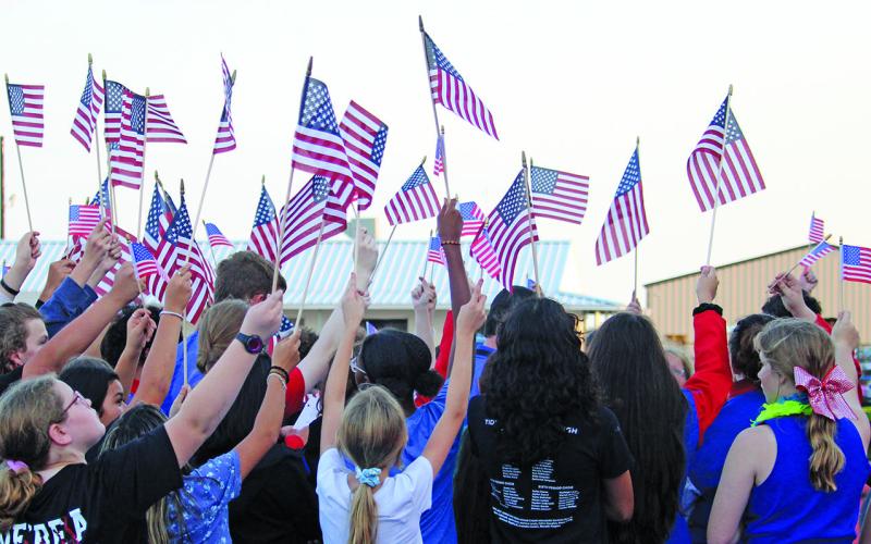 Tidehaven students make a great red, white and blue statement to observe the anniversary of 9/11. The profusion of flags and the Tiger football team’s display of much larger American flags all struck the appropriate tone of unity. Sentinel Photo/ Jessica Shepard