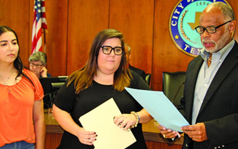Sentinel Photo/Mike Reddell Crisis Center of Matagorda and Wharton County representives Desiree Viesca (left), Outreach Advocate, and Samanth Counts, Outreach Manager, listen as Mayor Robert Nelson reads the city’s proclamation declaring October as Domestic Violence Awareness Month.