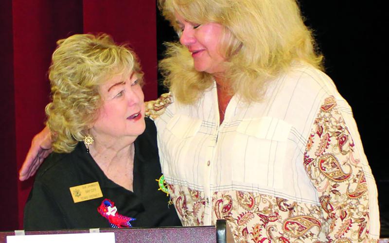 Sentinel Photo/MaLinda Reddell Pilot Club of Bay City President Sue Jahnsen hands off a memorial award to Sharyl McDonald in her mother Jeanette Opella's stead. The award recognizes Opella for her over 40 years of Pilot Club dedication and was featured at the Pilot International and district conventions earlier this year.
