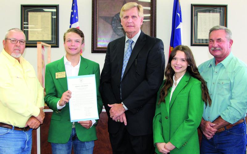 Sentinel Photo/Mike Reddell Commissioners Court approved a proclamation for Oct. 2-8 as National 4-H Week, at the court’s meeting Monday, Oct. 3. Shown, from left: Precinct 1 Commissioner Bubba Cook, Precinct 4 Commissioner Bubba Frick, 4-H member Ty Kubecka, County Judge Nate McDonald, 4-H member Ansley Kubecka, Precinct 3 Comissioner Troy Shimek and Precinct 2 Commissioner Kent Pollard.