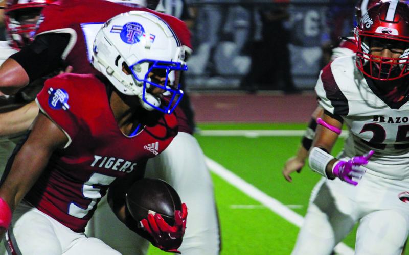 Sentinel Photo/Mike Reddell Tiger junior running back Joseph Dodds (5) looks for yardage  - en route to a 163-yard rushing game against Brazos last Friday.