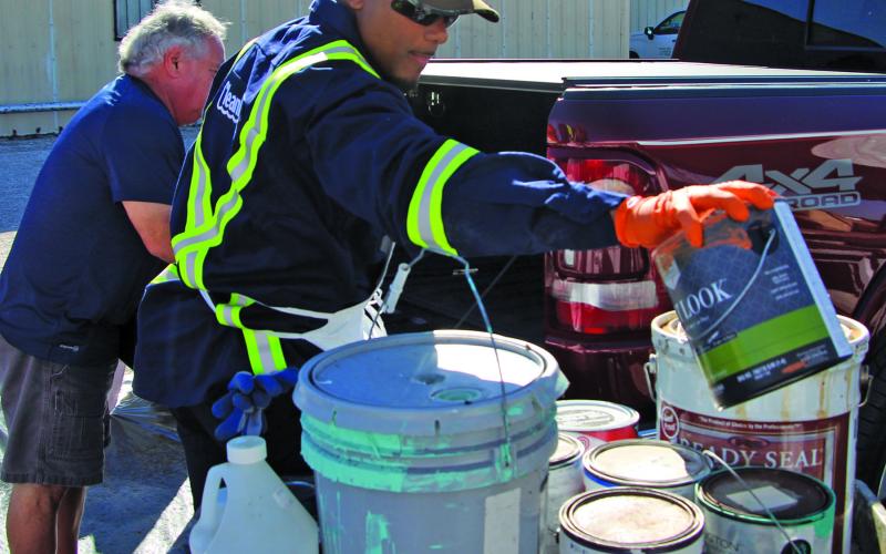 Sentinel Photo/Mike Reddell The Annual Household Hazardous Waste Collection Day was at the Matagorda County Fairgrounds Saturday, Oct. 1. This man with Clean Harbors helps remove a paint can from a pickup truck.