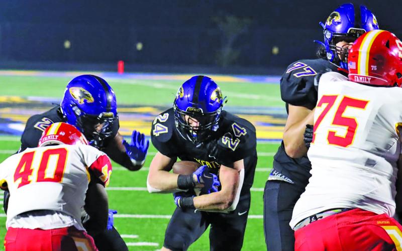 Live in the Moment/Le'Darion Stone Bay City blockers clear a path at the end zone for one of three touchdowns senior Ayden Smith (24) scored Friday night against Stafford.