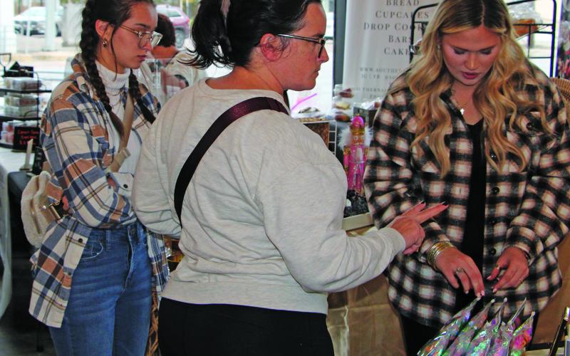 Eager Christmas shoppers hit the square to find this year's great gifts during "Christmas Around the Square" Thursday night.  Sentinel Photo/Mike ReddellEager Christmas shoppers hit the square to find this year's great gifts during "Christmas Around the Square" Thursday night.  Sentinel Photo/Mike Reddell