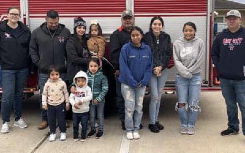 Contributed photo Each year, the Bay City Volunteer Fire Department sponsors a family for Christmas. This year, the department was able to put smiles on three faces and presents under their tree.