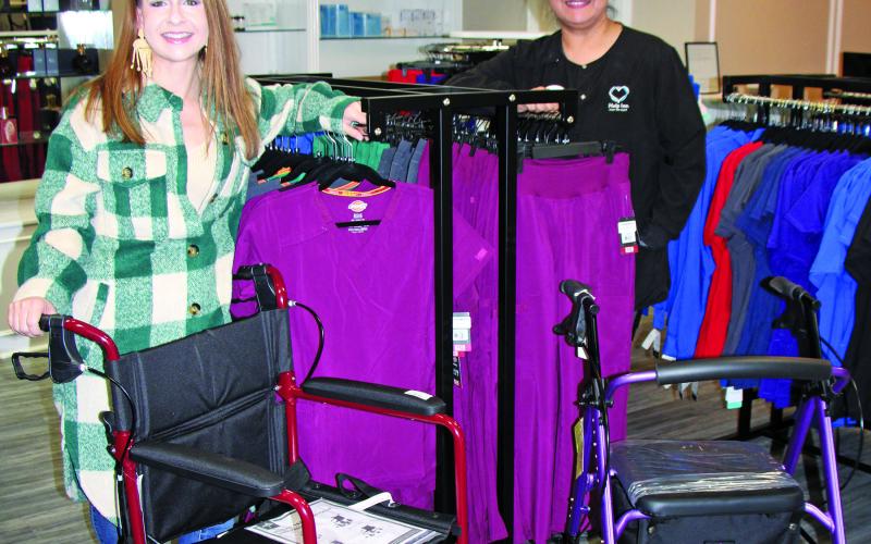 Sentinel Photo/Mike Reddell Help Inc. Business Development Manager Renee Laslie, left, and a fellow Help Inc. employee show off just some of the medical supplies available at the business during Christmas Around the Square, Nov. 17. Help Inc. also offers in-home care services and scrubs.