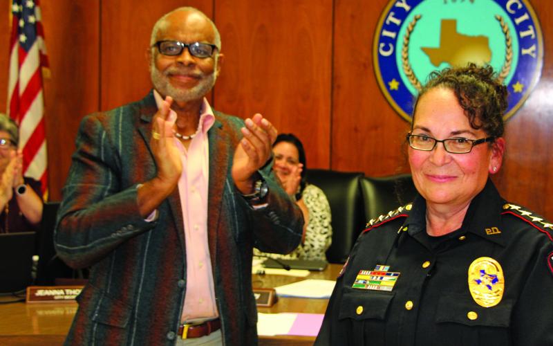 Sentinel Photo/Mike Reddell New Police Chief Christella Rodriguez stands amid loud applause led by Mayor Robert Nelson before a packed City Council Chamber after he administered her oath of office at council’s meeting Dec. 6.