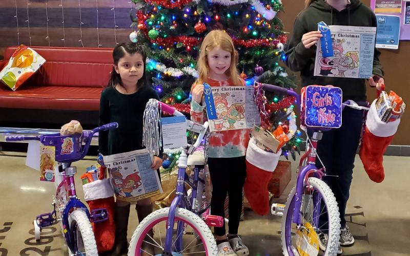 Sentinel Photo/MaLinda Reddell This year's Sentinel Christmas Coloring Contest winners are, from left, Denisse Palomares, Ruby Bonnot, and Ellasyn Milliff. Each girl received a bicycle, a blue ribbon for their artistry, and a Christmas stocking full of candy and other treats.