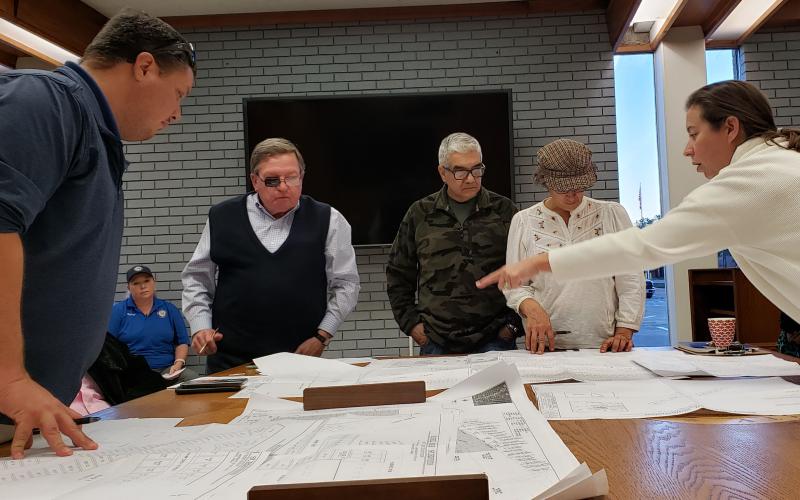 Sentinel Photo/Jessica Shepard Planning Commission board members review large-scale plans for subdivision plats before approving them Dec. 15.