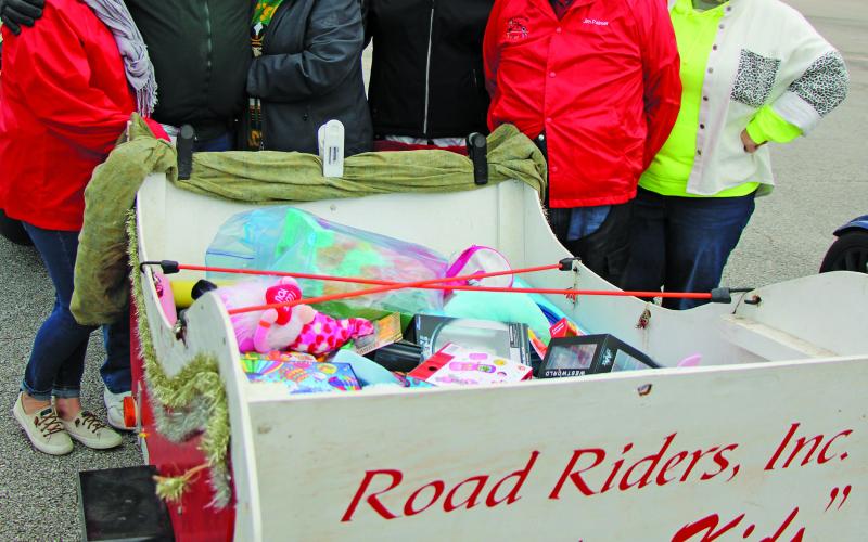 Sentinel Photo/Mike Reddell Members of Road Riders, Inc. prepare their annual delivery of “Toys and Kids” throughout Bay City on Saturday, Dec. 17. The Road Riders’ typically ride their motorcycles when delivering presents.