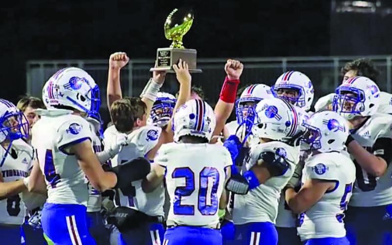 Courtesy Photo Tidehaven football team members celebrate the trophy designating them as the UIL Regional Semifinal Champions after defeating Brazos last Friday in Rosharon. The Tigers will travel to San Marcos this Friday to play Poth in the quarterfinal playoff at Texas State University.