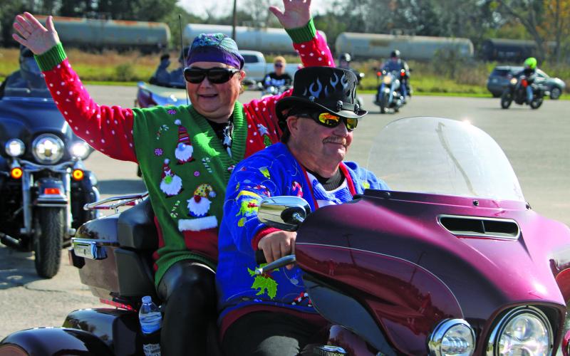 Sentinel Photo/Mike Reddell One rider in Sunday’s Toys for Kids motorcyle tour shows her enthusiasm. The tour is one of several events the organization puts on, leading up to its annual distribution of Christmas gifts to low-income children throughout Bay City on Dec. 17. There were 42 motorcyles in Sunday’s tour, which was a fundraising effort.