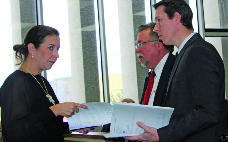 Sentinel Photo/Mike Reddell During discussions on the PCC Chemicals tax abatement request, BCCDC Executive Director Jessica Russell confers with MCEDC Executive Director Mike Ferdinand (center) and Tony Schum, Kroll director of site selection and incentives. There was a pause when County Attorney Jennifer Chau, via phone, noted the need to change a definition in the contract with PCC.