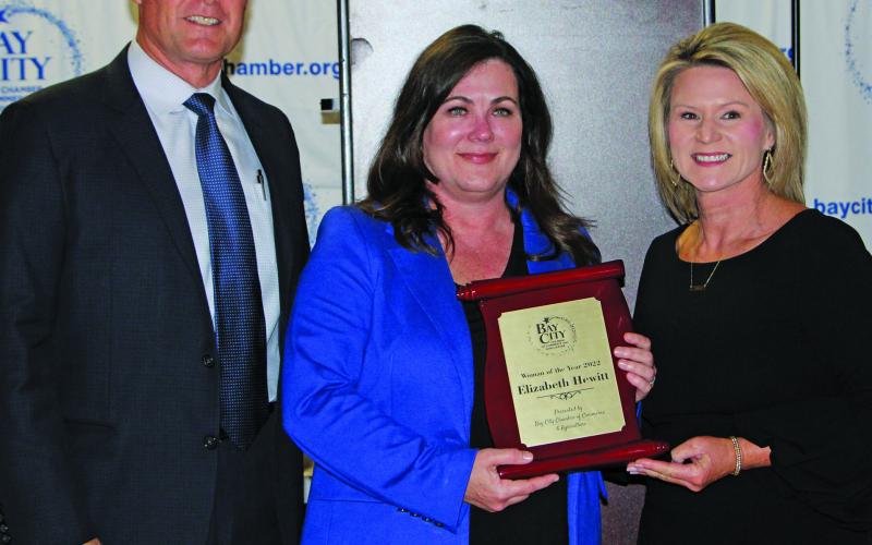 Sentinel Photo/MaLinda Reddell Chamber board chair Mark Bookmyer with Woman of the Year Elizabeth Hewitt and Biggerstaff, who is chamber chairman-elect.