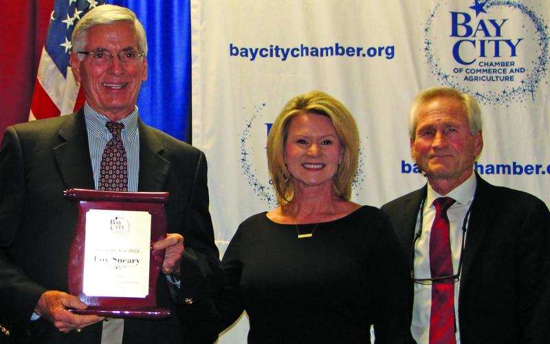 Sentinel Photo/MaLinda Reddell Loy Sneay shows off his 2022 Man of the Year award with Danyel Biggerstaff and Arthur Milberger, last year’s recipient. who introduced Sneary at the Bay City Chamber of Commerce and Agriculture banquet Thursday, Jan. 19.