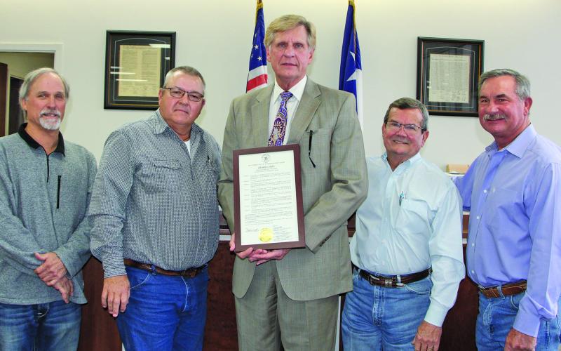 Sentinel Photo/Mike Reddell Matagorda County Commissioners Court approved resolutions that honored outgoing County Judge Nate McDonald and Precinct 2 Commissioner Kent Pollard at the court’s meeting Friday, Dec. 30. Above left, McDonald, center, holds his framed resolution, with commissioners, from left: Bubba Cook, Bubba Frick, Kent Pollard and Troy Shimek.