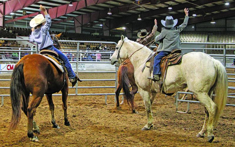 Matagorda County Fair events Saturday afternoon, Feb. 18, included youth and adult team penning. At left, a team indicates the job is done. Later that day was the Ranch Rodeo and Wild Cow Saddling. Sentinel Photo/Mike Reddell
