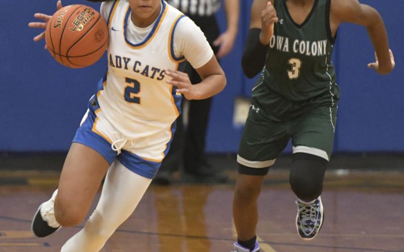 Larry Bose photo Ladycat sophomore point guard Alaysia Cook (2) hurries down court in a Jan. 25 contest against Iowa Colony that the girls won 58-38. The Ladycats have clinched the District 26-4A-1 crown and claim a 27-1, 11-0 record.
