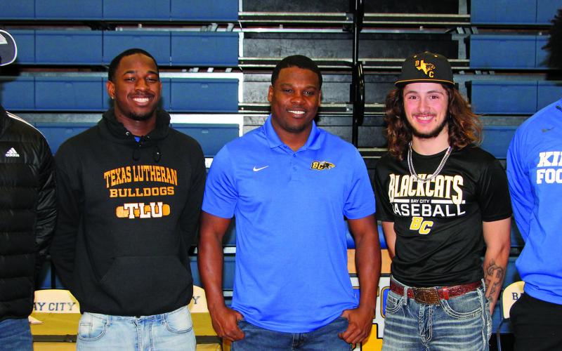 Sentinel photo/Mike Reddell Four Blackcat athletes signed college commitments at Bay City High School’s signing day celebration at the gym Feb. 1. The four - shown with Head Football Coach Robert Jones (center) - includes, from left: Brice Turner - football at the University of Nebraska; Josh Williams - football at Texas Lutheran University; Ashton Wallace - baseball at Arlington Baptist University; and Zo'maryon Bryan - football at Kilgore College.