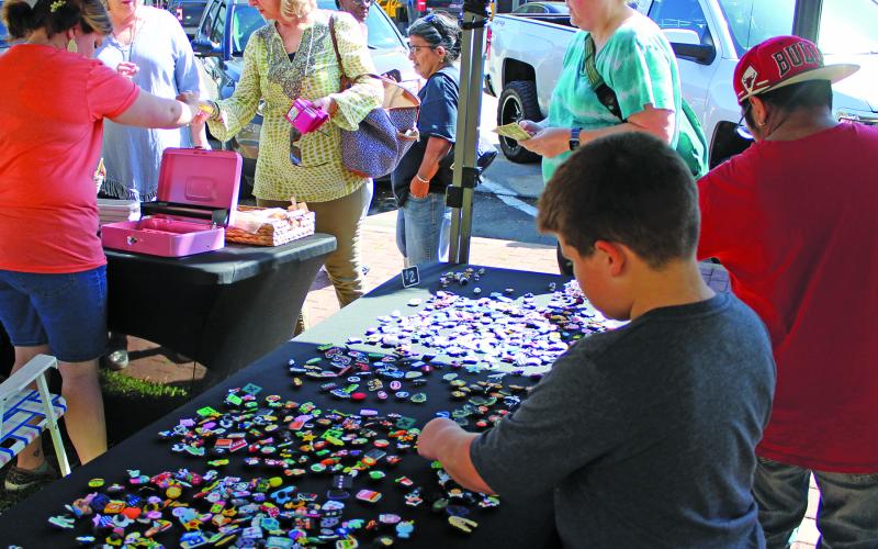 Sentinel Photo/Jessica Shepard Market Day made its return to downtown last Saturday. Vendor booths included croc charm selections, above, and everything from chamoy apples and fresh lemonade to sublimation T-shirts and metal yard art.