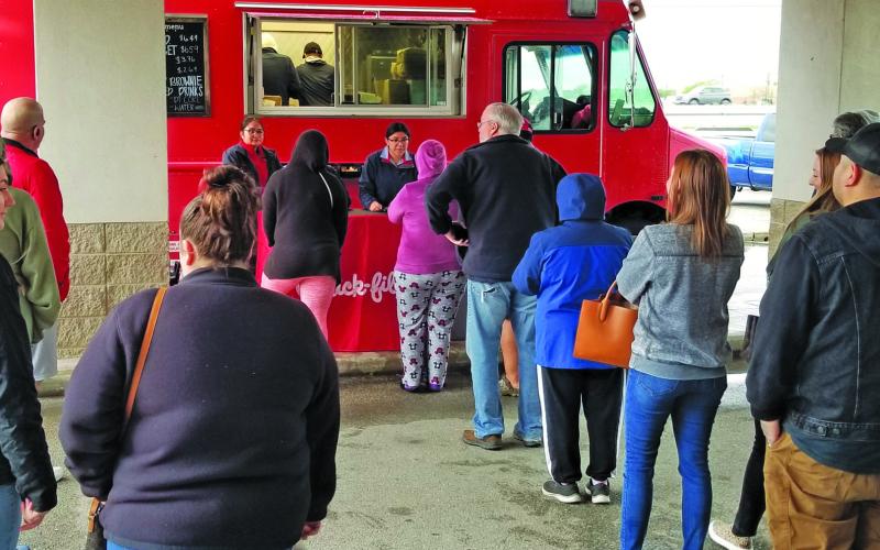 Sentinel Photo/Mike Reddell A Chick-fil-A truck served a long line of people when it stopped at Bay City Civic Center Friday, March 17. The restaurant proposes a location here.