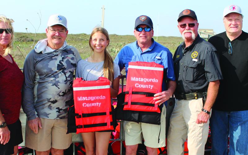 Sentinel Photo/Jessica Shepard Matagorda leaders and county officials joined Morgan Matherne (third from left) in launching her Girl Scout project to provide free life jackets to Matagorda Beach visitors Sunday, March 12. Shown, from left, are: Precinct 2 Justice of the Peace Suzanne Sullivan; Kent Pollard; Matherne; Precinct 2 Commissioner Mike Estlinbaum; Precinct 2 Constable Keith Sullivan; and County Judge Bobby Seiferman.