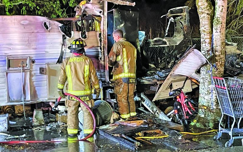Photo by Dan Shook Firefighters examine damage from this trailer fire at 2517 Nichols Street March 19.