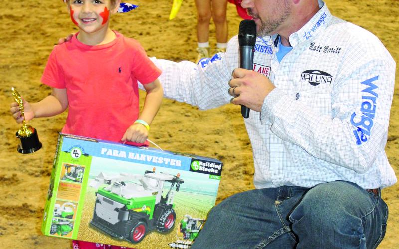 Sentinel Photo/Jessica Shepard Johnny Lee Alexander, 3 1/2 years old, was the winner of the fair’s Kids Rodeo Clown Contest Friday. Shown here with contest judge, PBR Rodeo Clown Matt Merritt, of Olin, N.C., the Sugar Land youngster was among 10 kids participating.