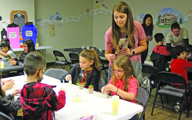 Sentinel Photo/Jessica Shepard Children and parents packed the Bay City Public Library during "Harry Potter Day" Thursday, March 16. Hogwarts-styled classes included potions making, above, along with herbology, picking out wands, and being sorted into each respective Hogwarts house.