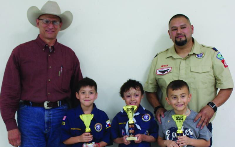 Sentinel Photo/Jessica Shepard Bay City Cub Scout Pack 4545 held its annual cake auction fundraiser Friday, March 24. Auctioneer Rick Deleon, left, poses with cake category winners Hunter Hornback, Oliver Flores, Emerson Morris, and Pack Leader Israel Moya.