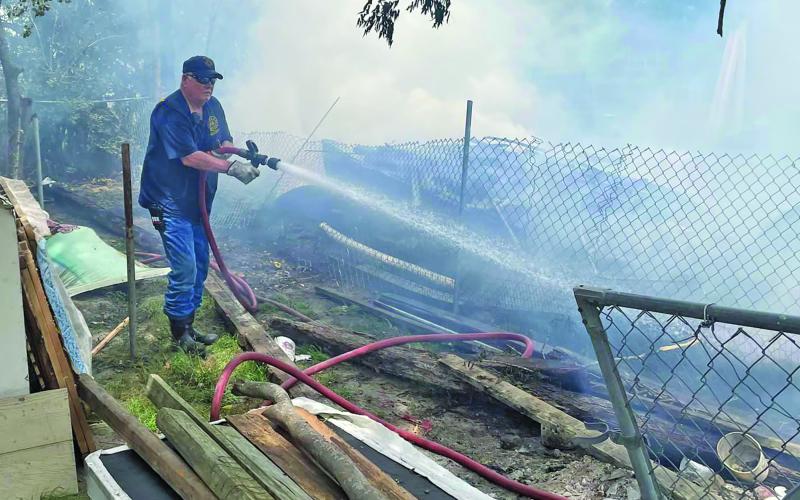 Photo by Fire Marshal Dan Shook A Bay City firefighters battles a blaze caused by an unattended barrell container.