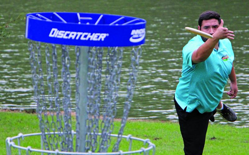 Sentinel Photo/Mike Reddell A disc golfer tosses his “putt” at the Bay City Big Oak Challenge at LeTulle Park Saturday, May 13. The first-time event here drew 71 skilled disc golfers - most of them from out of town. See more photos, Page 6.