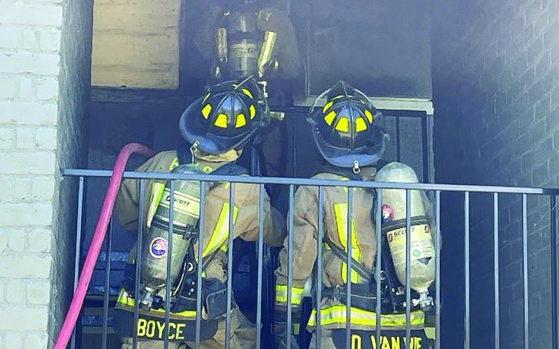 Photo by Dan Shook Bay City firefighters battle a blaze in a Hiram Brandon apartment building stairwell April 28.