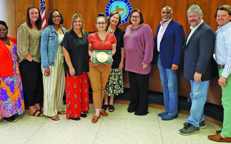 Sentinel Photo/Jessica Shepard Bay City Finance Director Scotty Jones and her department received the Government Finance Officers Association’s “Distinguished Budget Presentation Award” during council’s regular meeting last week. Bay City has received this award since 2016 along with the “Triple Crown” medallion since 2019.