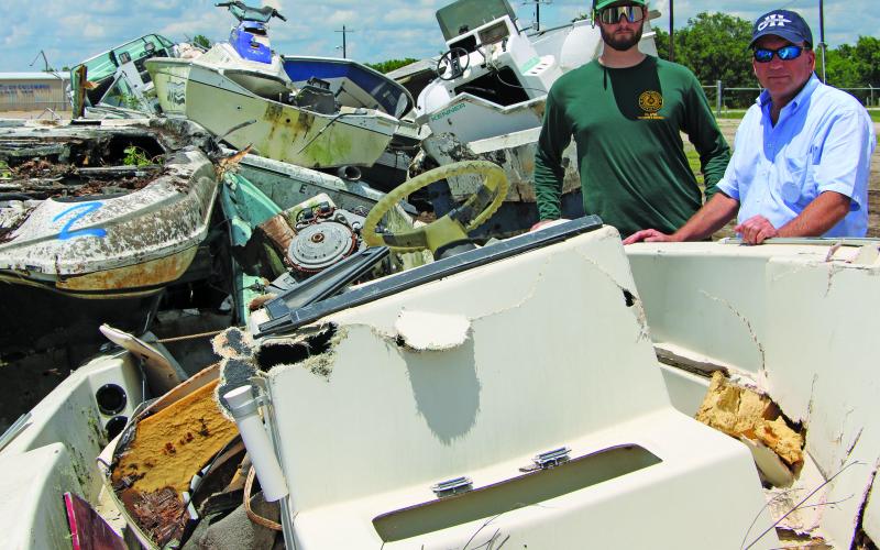 Sentinel Photo/Mike Reddell A total of 56 boats were collected in Matagorda County’s vessel return program, said Precinct 2 Commissioner Mike Estlinbaum. Estlinbaum, right, is shown with Kurt Adams, response officer with the General Land Office (GLO), with some of the early boats turned in last week. Estlinbaum thanked those who hauled the boats to the Fairgrounds for proper disposal and help rid the county of eyesore boats littering property.