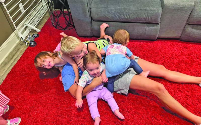 Contributed photo Jessica Russell finds herself beneath her children in a family dogpile recently.