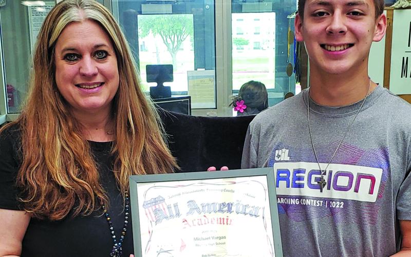 BCHS Academic Dean Mary Lynn Mosier-Flores presenting Michael Vargas with his NISCA Academic All-America certificate.