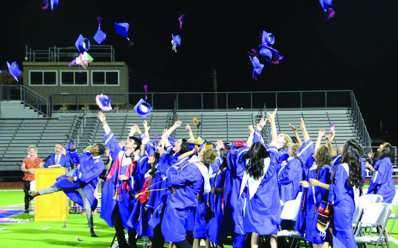 Sentinel Photo/Jessica Shepard Newly minted Tidehaven graduates throw their mortarboard caps.