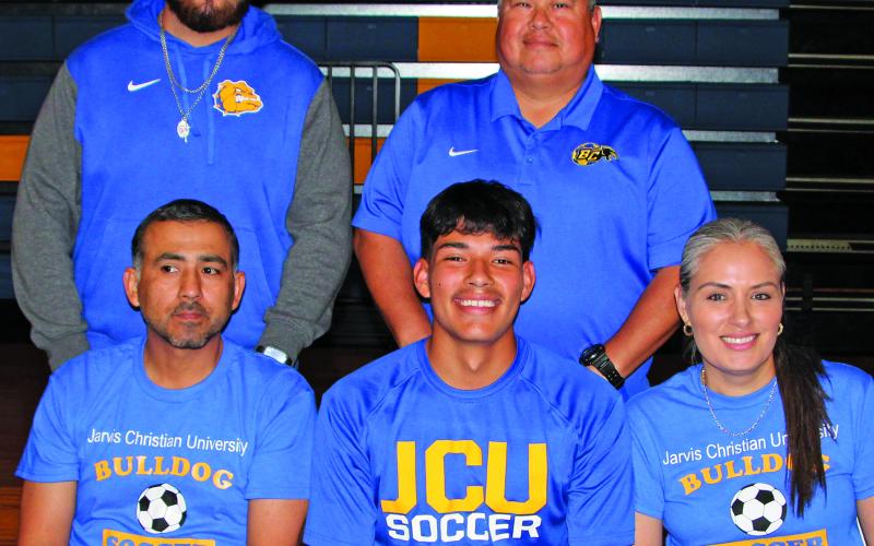 Sentinel photo/Mike Reddell Victor Morales (center, seated) signed a commitment to play soccer with Jarvis Christian University in Hawkins, Texas. Morales was goalkeeper of the year twice, and first team All District in soccer two years in a row and a three-year varsity football player.