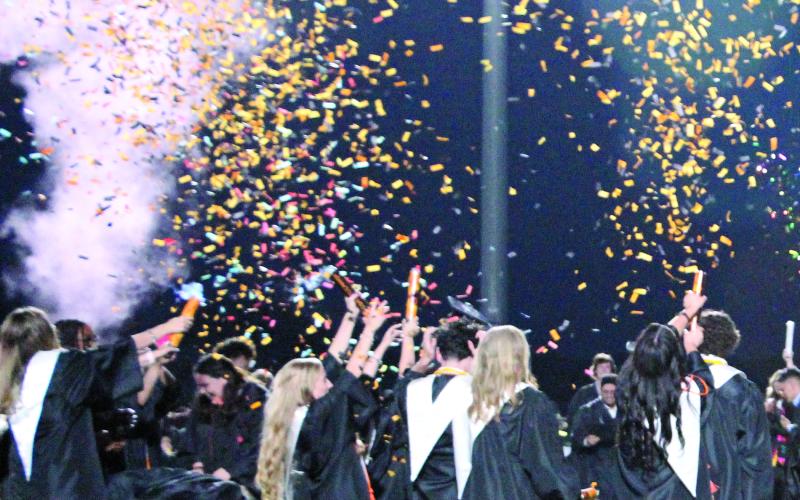 Sentinel Photo/Jessica Shepard Van Vleck High School's Class of 2023 added confetti and colored powder cannons to their traditional cap-throwing finale for the graduation ceremony.
