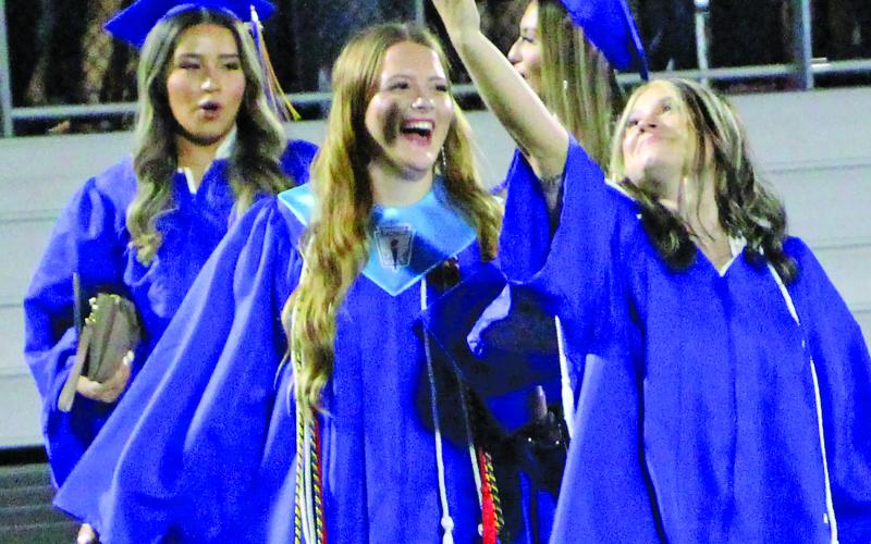 Sentinel Photo/Jessica Shepard Several Bay City High School graduates took time to snap a few selfies with their friends before throwing their mortarboard caps.