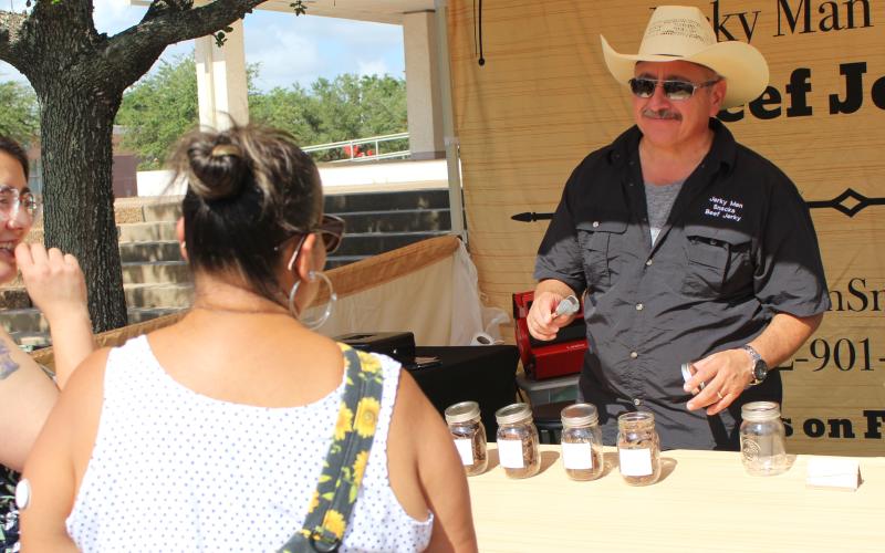 Sentinel Photo/Jessica Shepard A new vendor "Jerky Man Snacks" offered a variety of beef jerky samples to interested customers at his booth during Downtown Bay City Market Day last Saturday, July 22. Market Day returns to the Matagorda County Courthouse square every fourth Saturday of the month with vendors and ware ranging from homemade and handcrafted to Tupperware and Scentsy items.