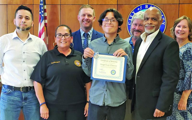 Sentinel Photo/Jessica Shepard Mayor Robert Nelson presented a "Certificate for Bravery" to 15-year-old Angel Lee Chavez for his life-saving actions on May 21 helping family members escape from being trapped in their car after a head-on collision during City Council's meeting last week. For setting an example for other youth and Bay City citizens, Bay City PD Chief Christella Rodriguez sponsored the award and handed Chavez the "Chief's Coin."