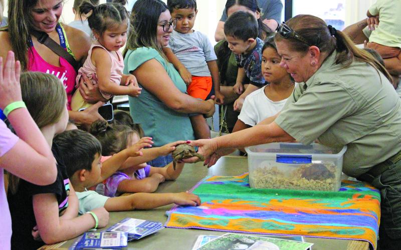 Sentinel Photo/Jessica Shepard Animal Control Officer Dotty Grandstaff discussed animal safety for wild and domestic animals during the Bay City Public Library's "Tales &amp; Tails" event Monday, July 3. Grandstaff also allowed children to pet rescued turtles, tortoises, and her own dog, Mia.