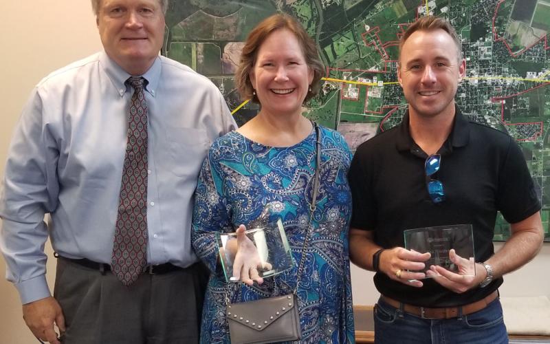 Matagorda County Economic Development Corporation (MCEDC) Chairman Bobby Seiferman, left, presented past service awards at last week’s MCEDC board meeting to past board members Becca Sitz and Erik Frankson. Sentinel Photo/Mike Reddell
