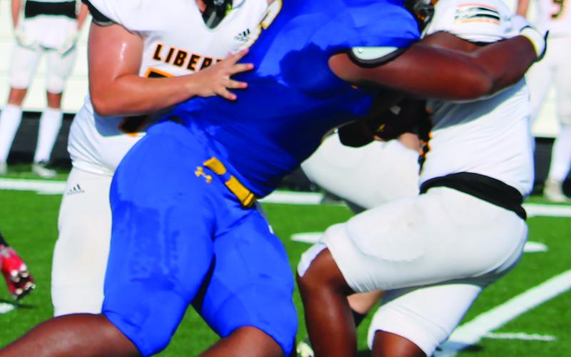 Sentinel Photo/Mike Reddell Bay City senior defensive end Carlon Jones (6) makes an stop on a Liberty runner.
