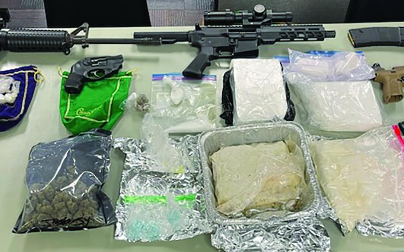 Police show guns and drugs taken after search warrant was served at 2900 block of Avenue I