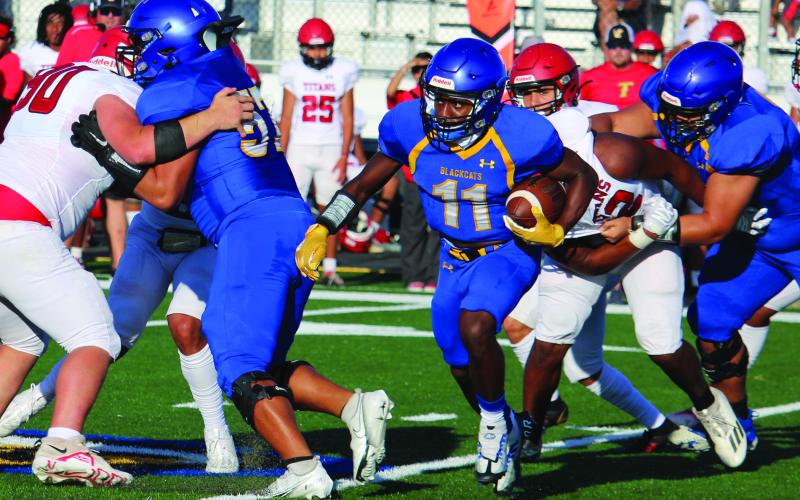 Sentinel Photo/Mike Reddell Above, junior Blackcat running back Jada Andrews (11) follows his blockers in last week’s scrimmage with Victoria East. Bay City will play Sweeny here this Friday.