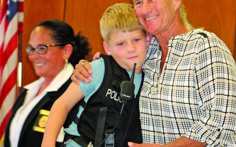Owen Lyons gets a hug from Suzanne Sullivan, after Chief Christella Rodriguez gives him oath of office. Sentinel photo: Mike Reddell